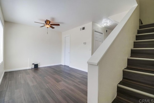 staircase featuring ceiling fan and wood-type flooring