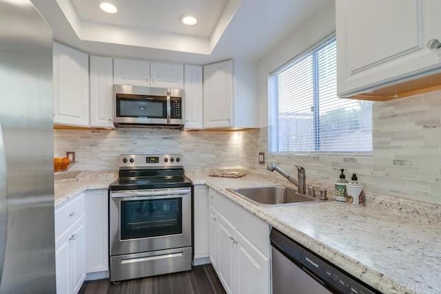 kitchen with sink, white cabinets, and stainless steel appliances