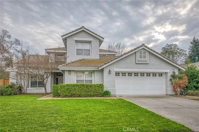 view of property featuring a front yard and a garage