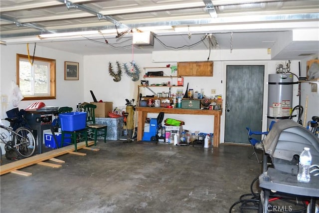 garage featuring a workshop area, strapped water heater, and a garage door opener