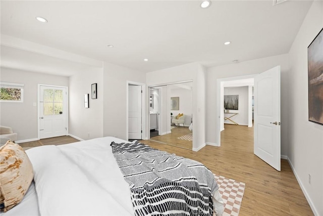 bedroom with a closet and light hardwood / wood-style flooring