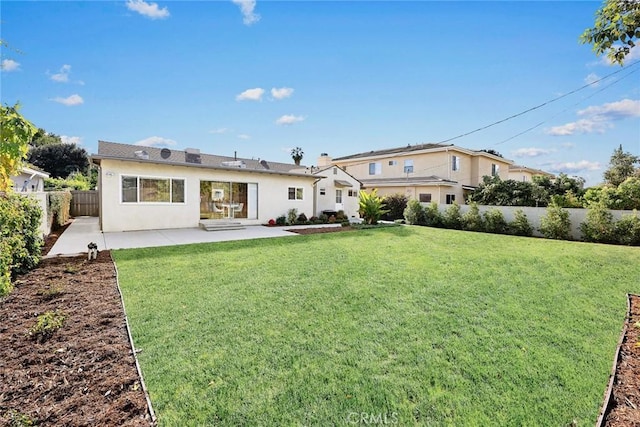 back of house featuring a patio area and a yard