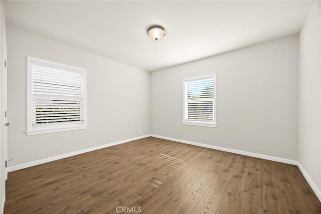 empty room featuring dark wood-type flooring