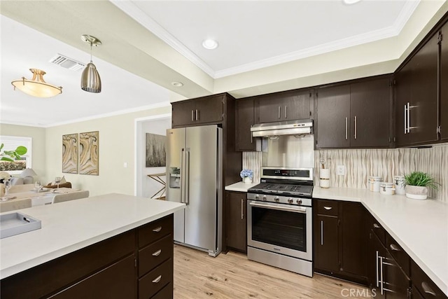 kitchen with dark brown cabinetry, appliances with stainless steel finishes, decorative backsplash, and pendant lighting