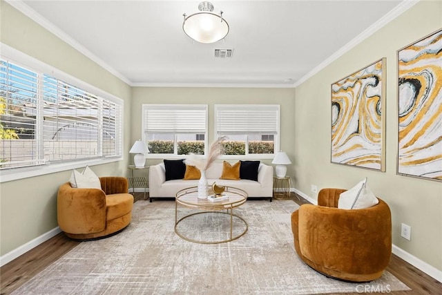 sitting room with wood-type flooring and crown molding