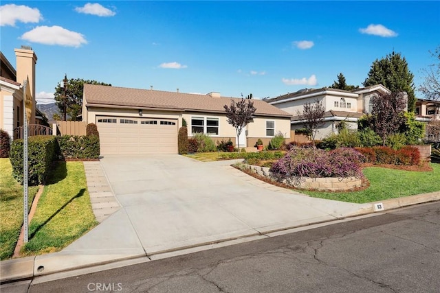 view of front of home with a front lawn and a garage