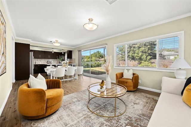 living room with wood-type flooring and crown molding