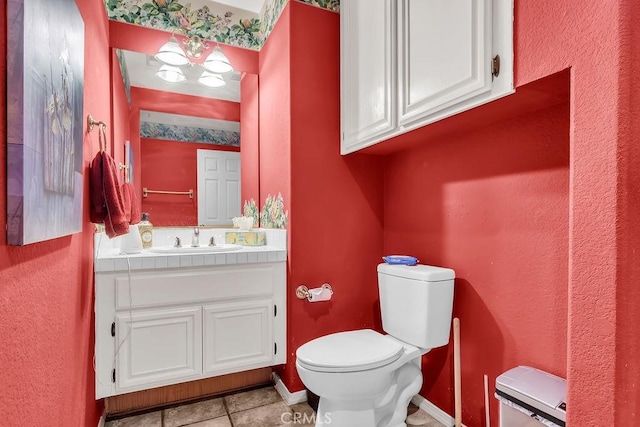 bathroom with toilet, tile patterned floors, and vanity