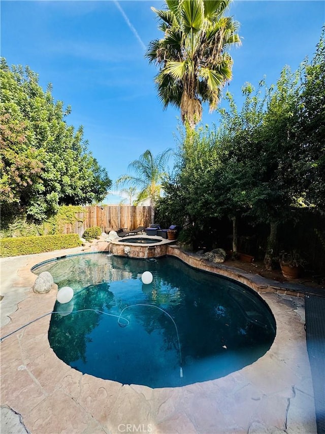 view of pool featuring an in ground hot tub