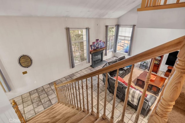 staircase featuring lofted ceiling