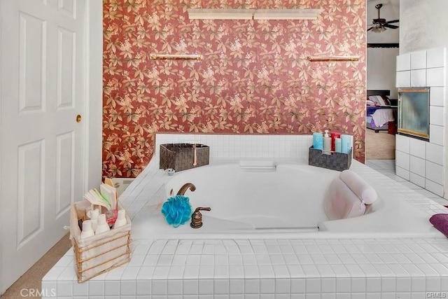 bathroom featuring ceiling fan and a relaxing tiled tub