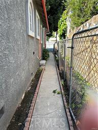 4943 Granada St, Los Angeles, CA 90042 - view of home's exterior featuring stucco siding, a gate, and fence