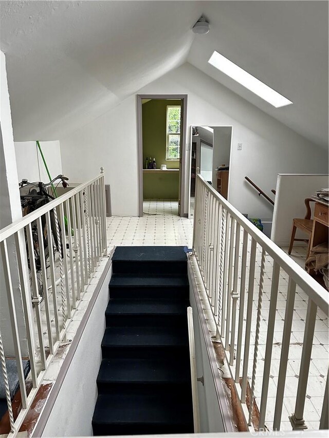4943 Granada St, Los Angeles, CA 90042 - stairway featuring lofted ceiling with skylight