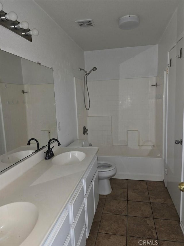 full bathroom featuring vanity, toilet, tile patterned floors, and shower / washtub combination