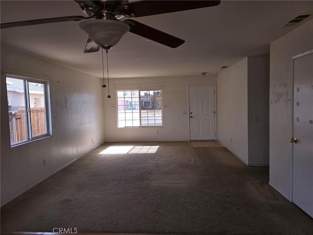 empty room with ceiling fan and carpet