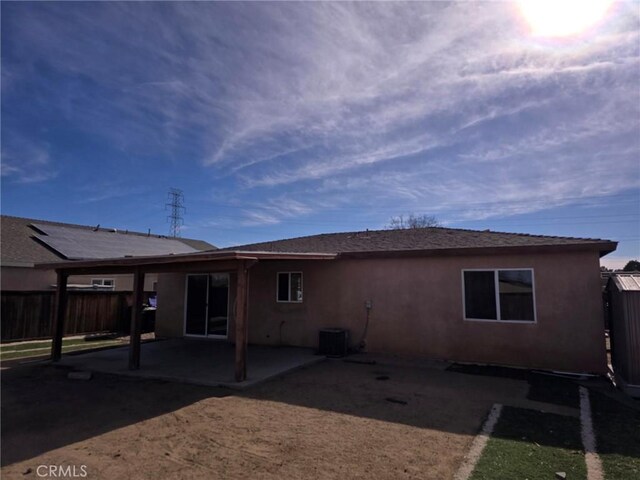 rear view of property featuring cooling unit and a patio area