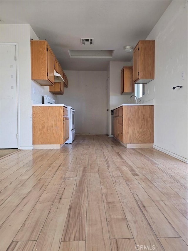 kitchen with light hardwood / wood-style flooring and electric stove