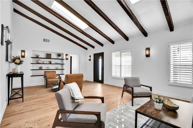 living room featuring high vaulted ceiling, beam ceiling, and light wood-type flooring