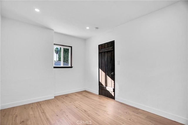 spare room with light hardwood / wood-style floors