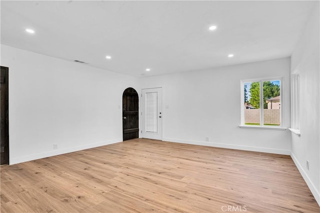 empty room with light hardwood / wood-style flooring