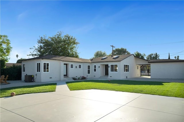 ranch-style home with central AC and a front yard