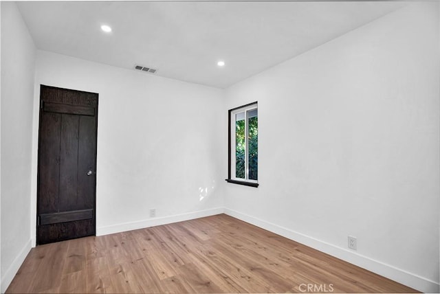 unfurnished room with light wood-type flooring