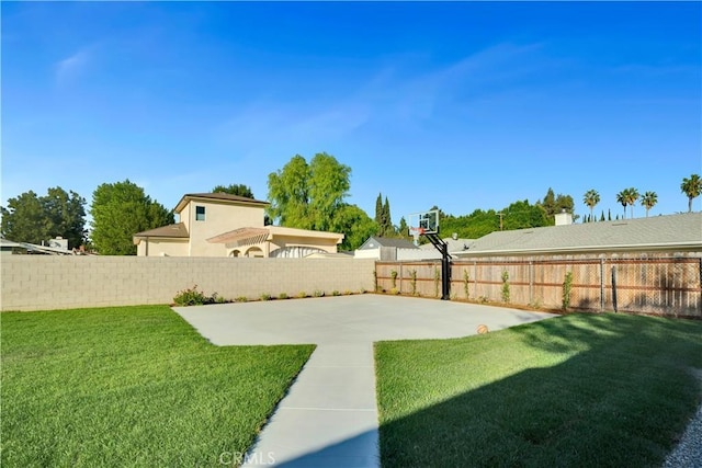 view of yard with basketball hoop