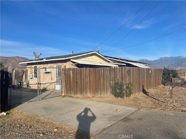 view of property exterior with a mountain view