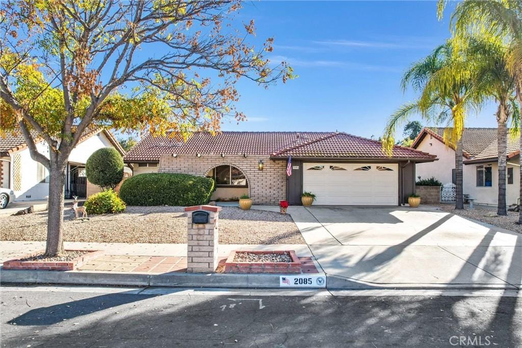 mediterranean / spanish-style home with a garage