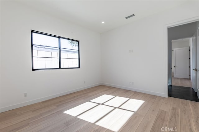 spare room with light hardwood / wood-style flooring