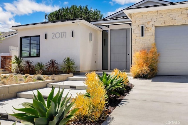 doorway to property with a garage