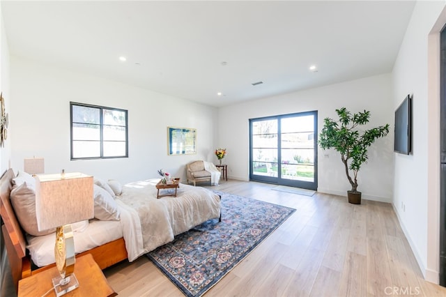 bedroom featuring access to outside and light hardwood / wood-style floors