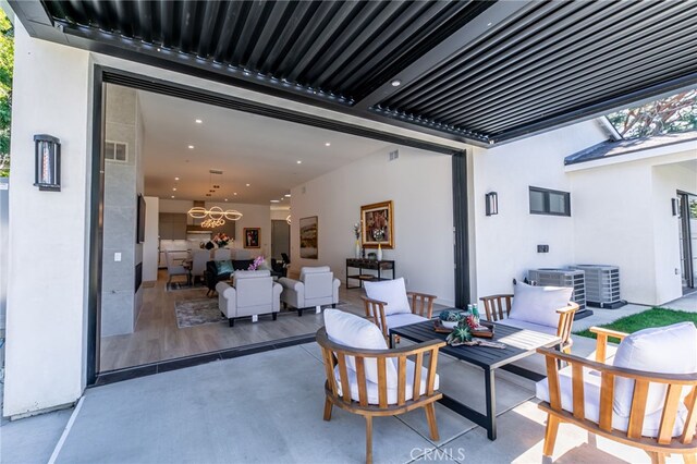 view of patio / terrace featuring an outdoor living space and central AC