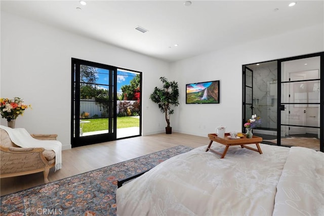 bedroom with access to exterior and light hardwood / wood-style flooring