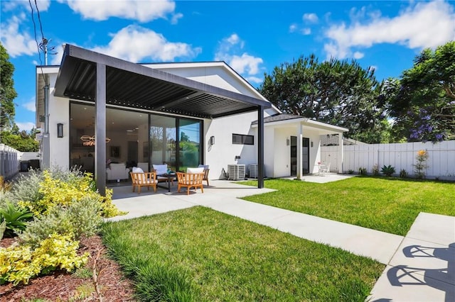 rear view of property with a lawn, central air condition unit, an outdoor hangout area, and a patio