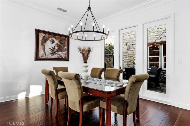 dining area featuring dark wood-type flooring and crown molding