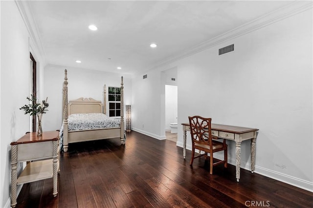 bedroom with connected bathroom, dark hardwood / wood-style flooring, and ornamental molding