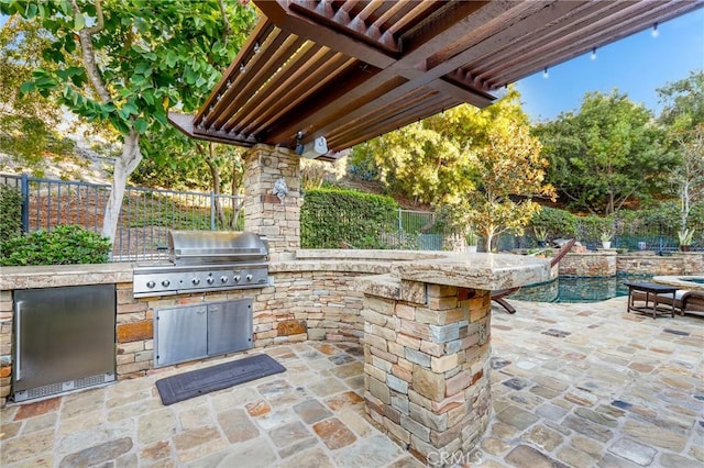 view of patio featuring a grill and exterior kitchen