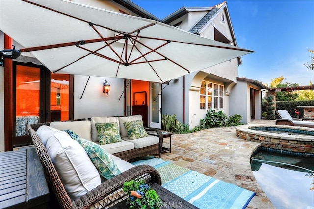 view of patio featuring outdoor lounge area and an in ground hot tub