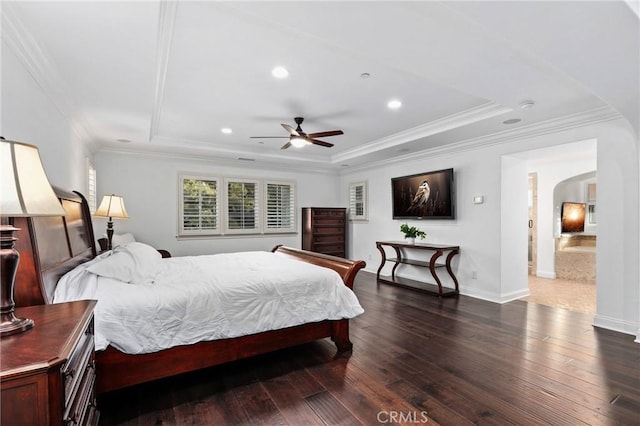 bedroom featuring ceiling fan, dark hardwood / wood-style flooring, and a tray ceiling