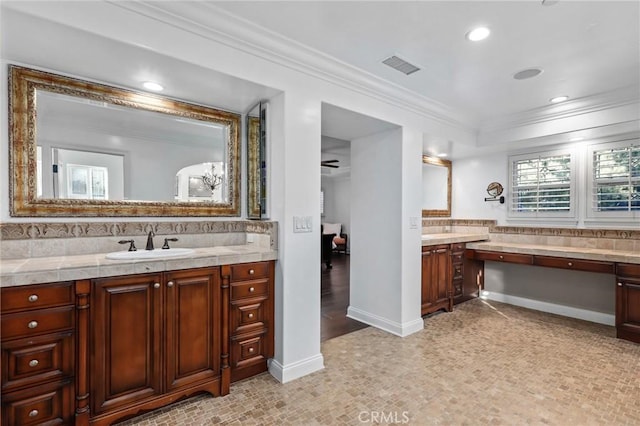 bathroom featuring vanity, ornamental molding, and tasteful backsplash