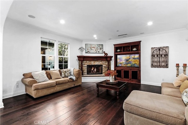 living room featuring dark hardwood / wood-style flooring, a fireplace, and ornamental molding