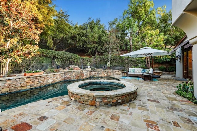 view of patio with an outdoor living space and a swimming pool with hot tub