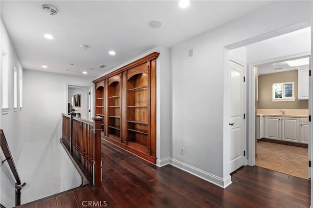 hall featuring dark wood-type flooring and sink