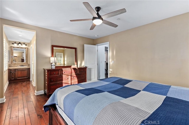 bedroom featuring ceiling fan, dark wood-type flooring, and connected bathroom