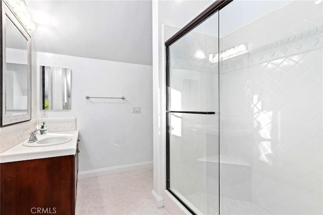 bathroom with tile patterned flooring, a shower with shower door, and vanity