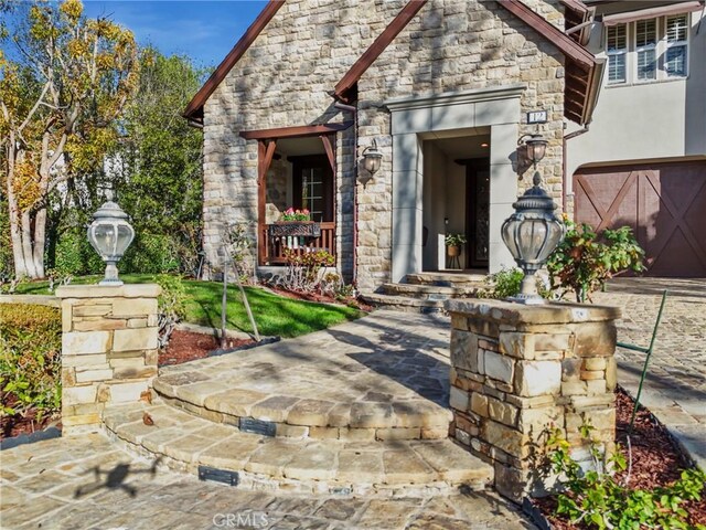 view of exterior entry with a garage