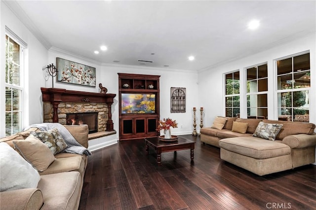 living room featuring dark wood-type flooring, ornamental molding, and a fireplace