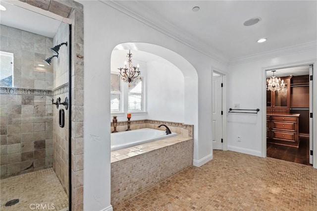 bathroom with crown molding, a chandelier, and shower with separate bathtub