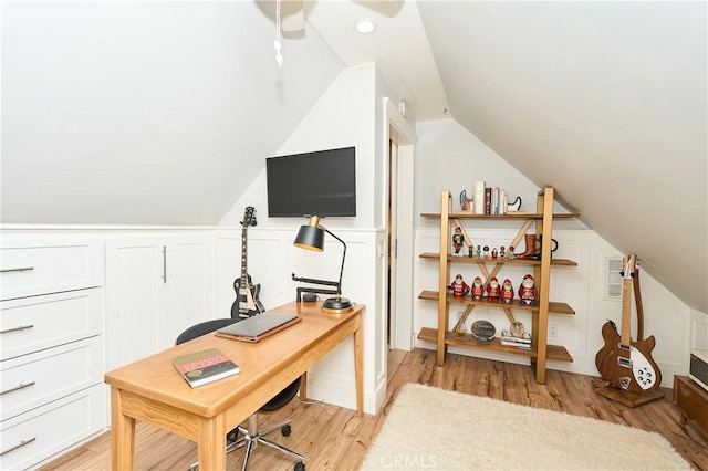 office with lofted ceiling and light hardwood / wood-style flooring